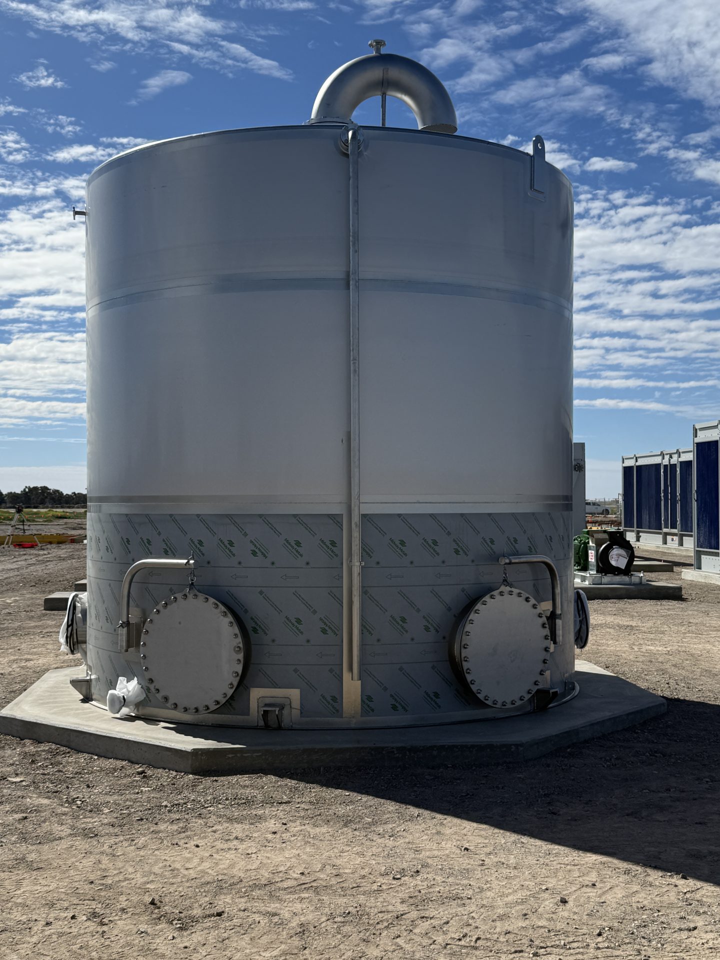 A 45kL stainless steel water tank on a concrete base on site